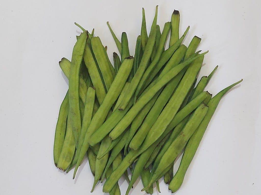Fresh cluster beans (guar) on a white background