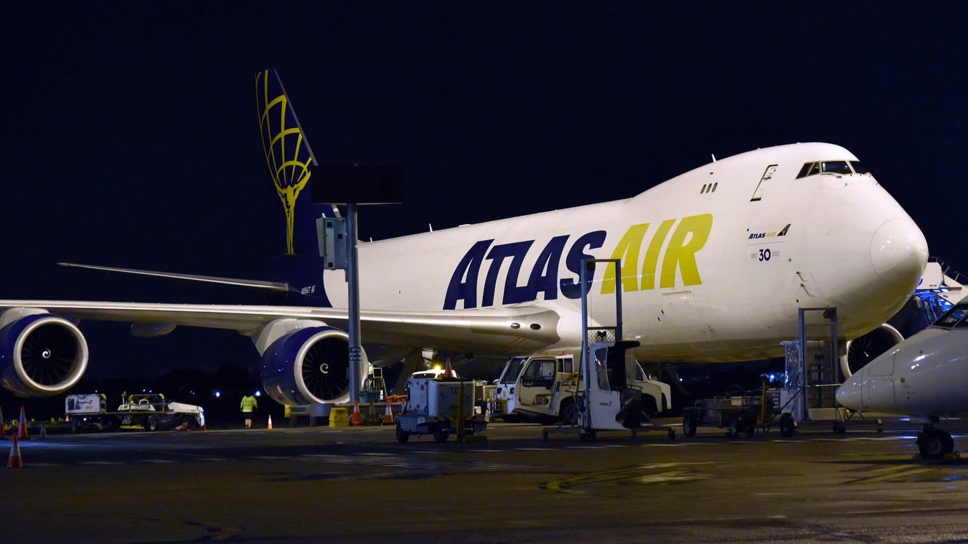Cargo freighter aircraft being loaded at night